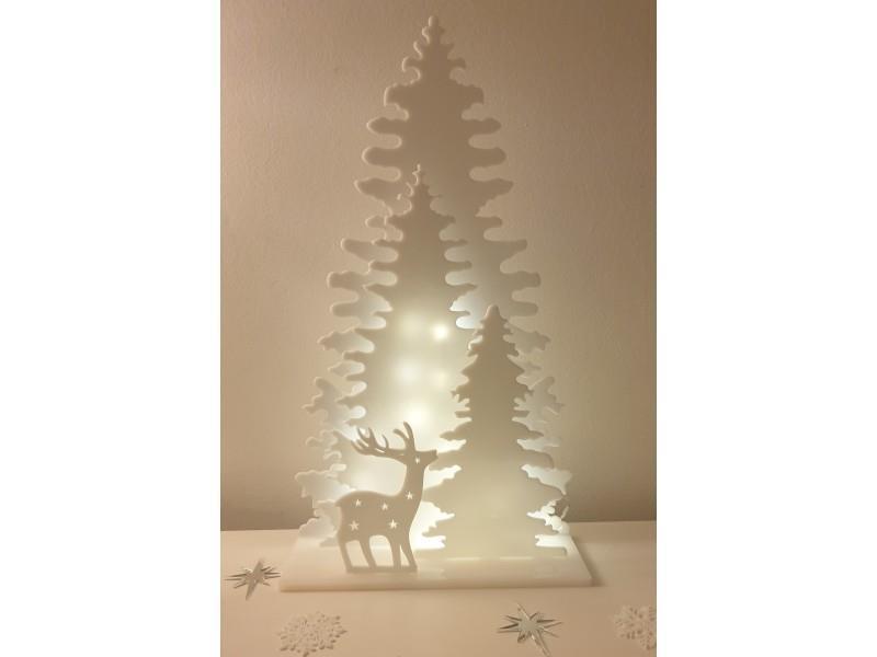 Spruces on a base with a deer