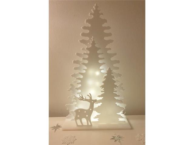 Spruces on a base with a deer